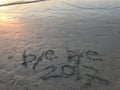 Words Ã¢â¬Åbye bye 2017Ã¢â¬Â on the beach with beautiful orange light from sunset